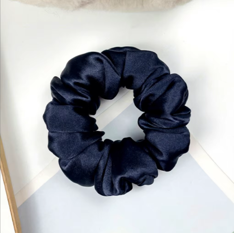 Scrunchie aus Seide in Nachtblau auf hellem Hintergrund